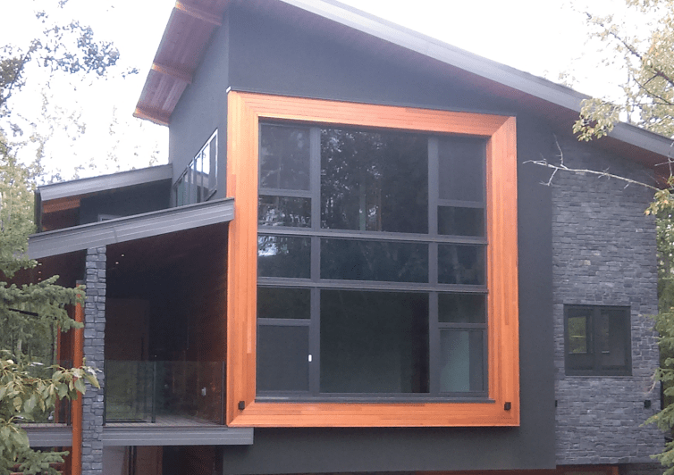 Clean Windows on Residential Black House and Orange Trim