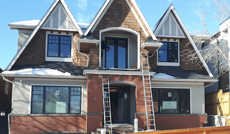 Clean Windows on Residential House Spring With Snow on Roofs