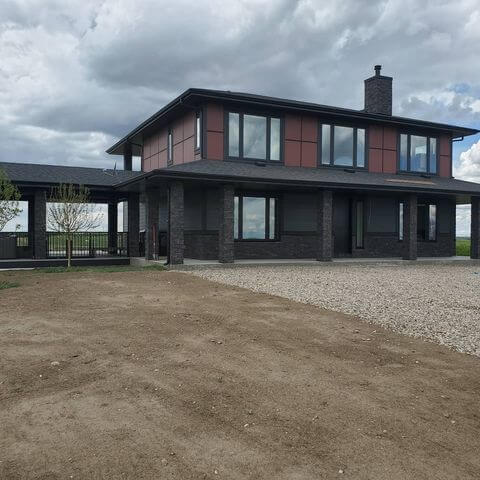 Clean Windows on Residential House With Dirt Road