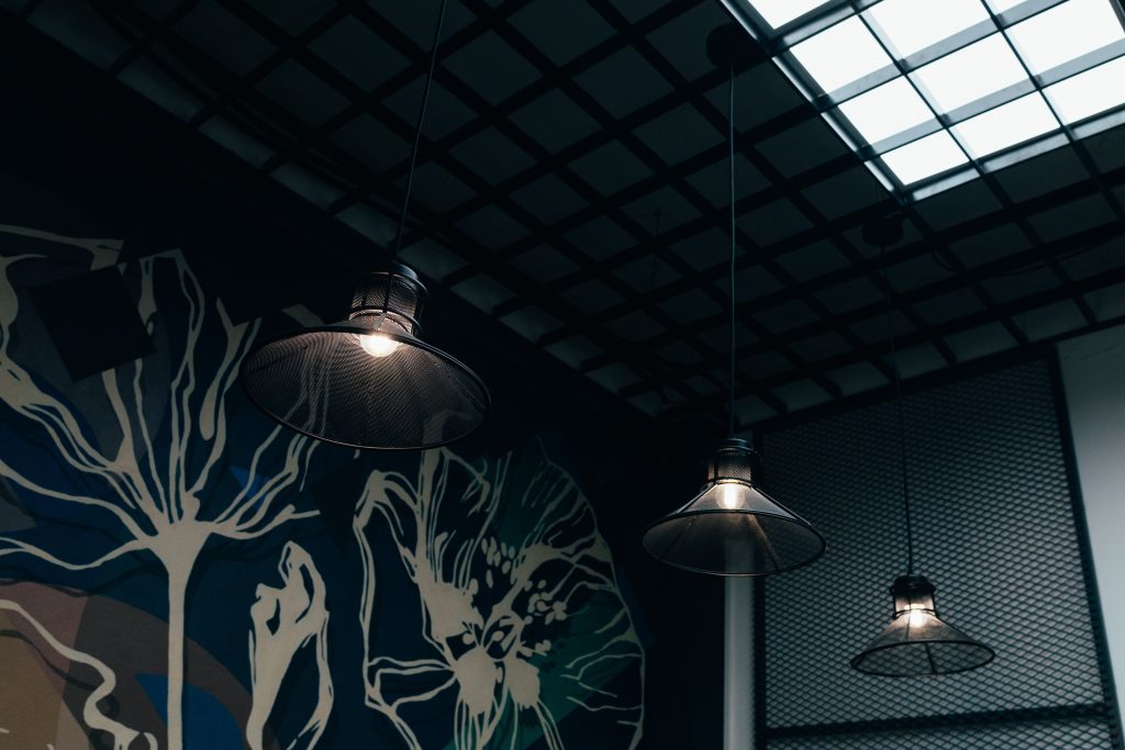 ceiling with black wall and hanging lamp lights
